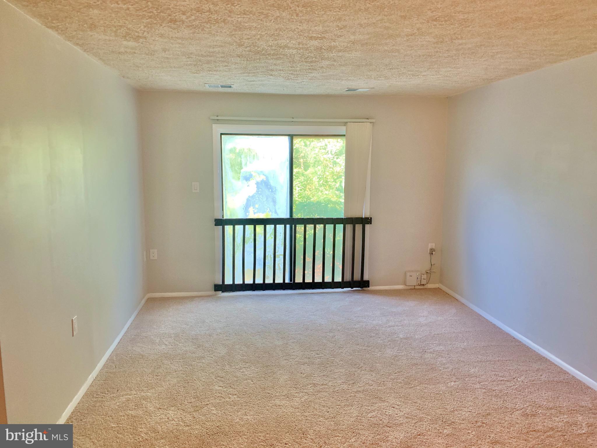 3926 Rolling Rd., Unit 11D Baltimore, MD 21208 - Photo 8 of 22 Living Room w/ overlook to tree-lined common area