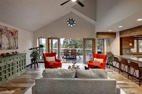 a living room with patio furniture and a chandelier