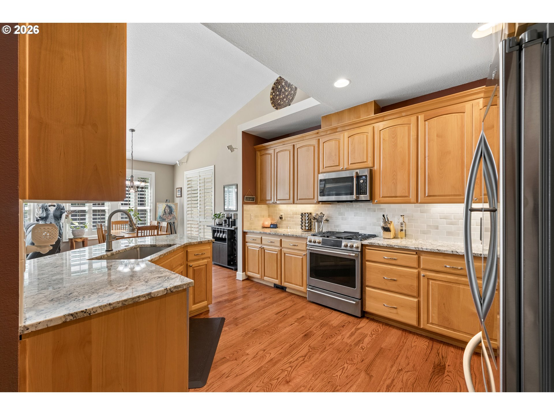 945 Northwest Angel Heights Road Stevenson, WA 98648 - Photo 14 of 41 a kitchen with stainless steel appliances granite countertop a refrigerator a sink dishwasher a stove with wooden cabinets and floor
