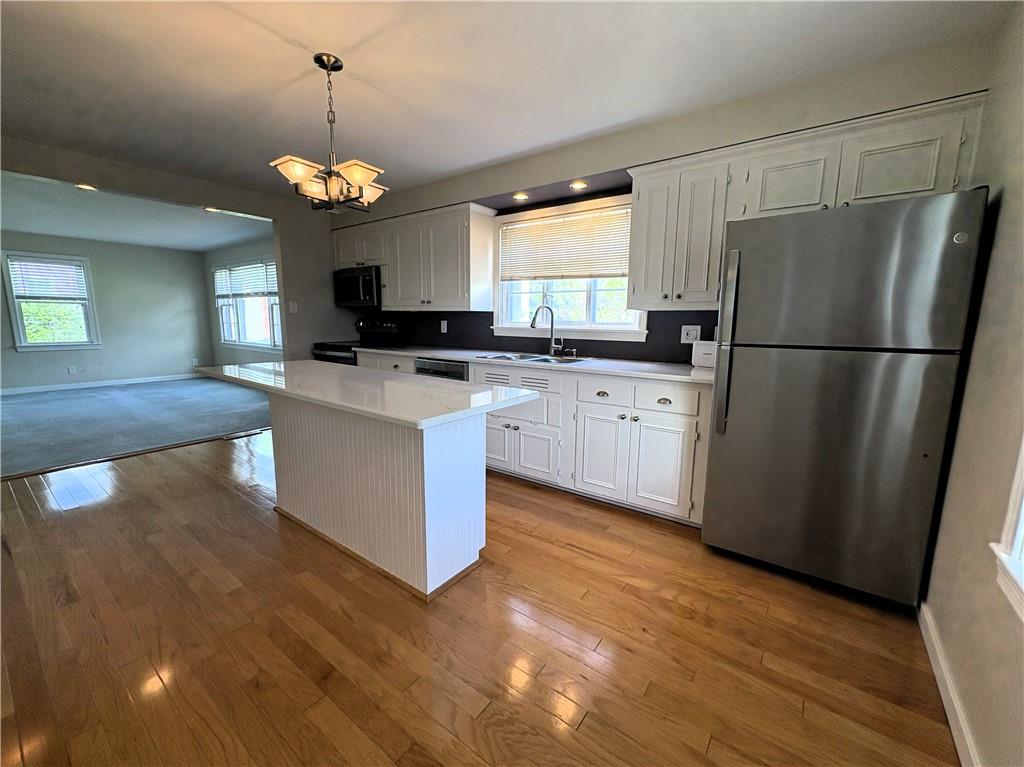 122 Browns Hill Road Valencia, PA 16059 - Photo 6 of 18 a large kitchen with a chandelier stainless steel appliances and a chandelier