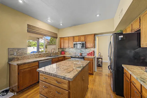 a kitchen with a stove a refrigerator and a sink