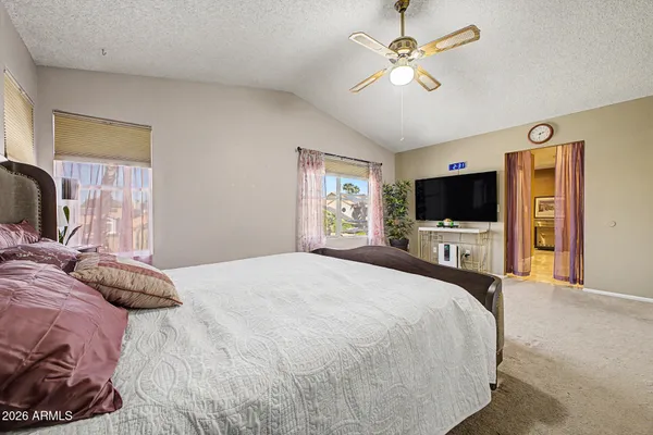 a bedroom with a bed and a flat screen tv