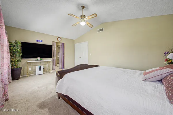a bedroom with a flat screen tv and a bed