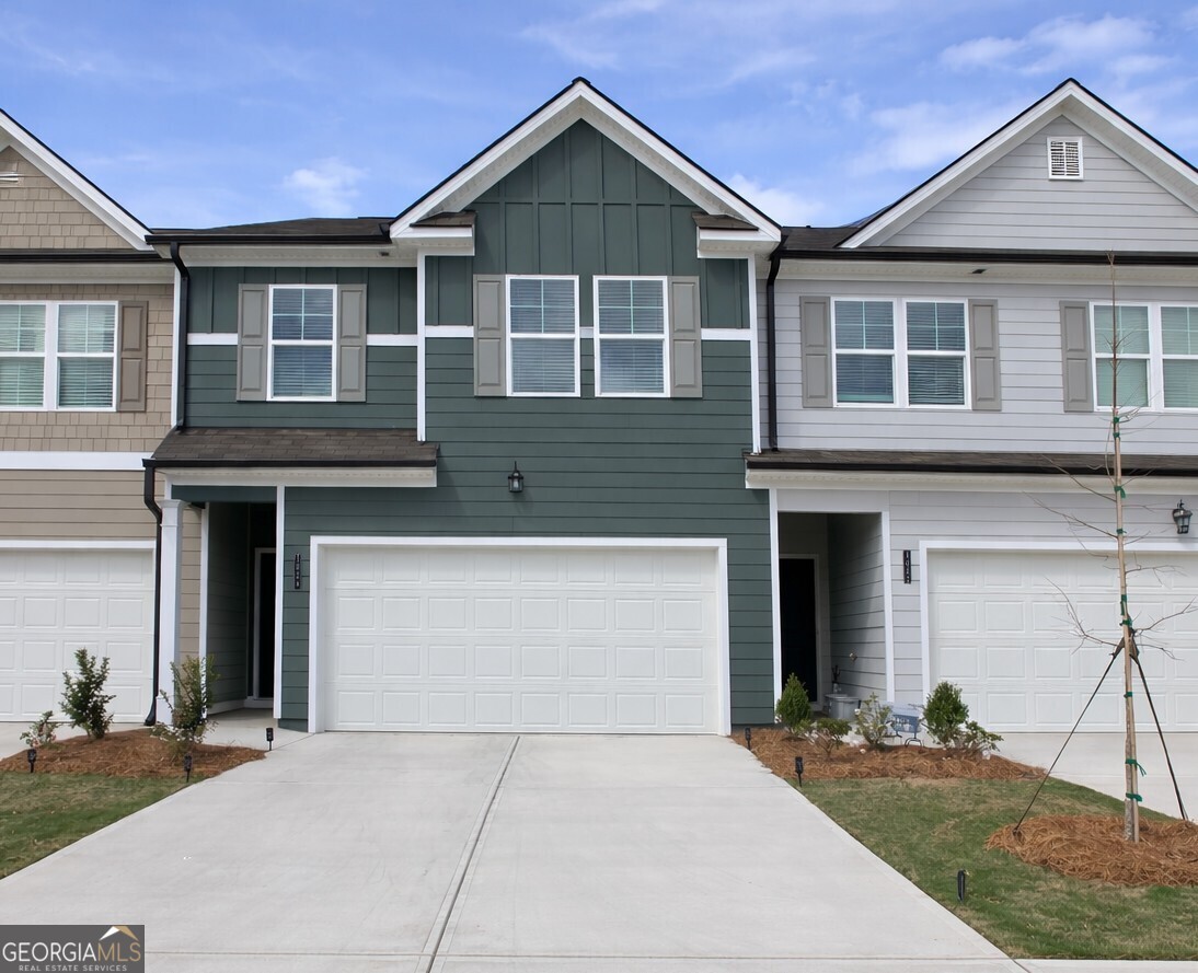 1053 Merritt Drive, Unit 85 Villa Rica, GA 30180 - Photo 2 of 2 a front view of a house with a yard and garage