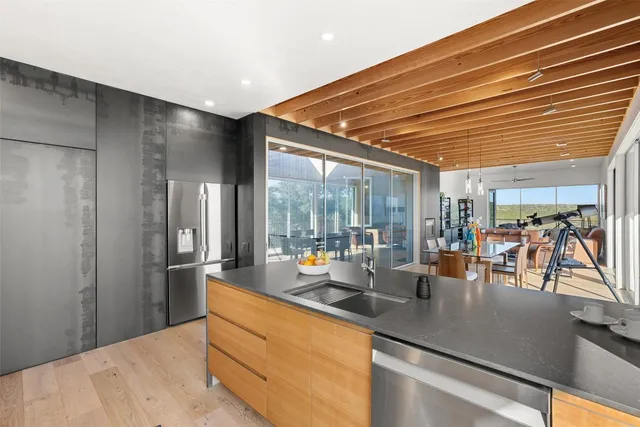 a kitchen with stainless steel appliances granite countertop a sink and cabinets