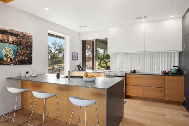 a kitchen with granite countertop a sink stove and refrigerator