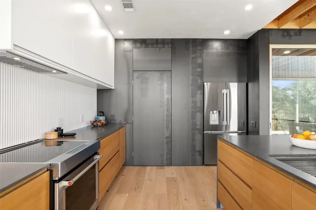 a view of a patio with dining table and chairs with wooden floor and fence