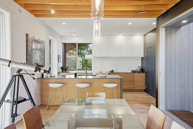 a living room with furniture a flat screen tv and a large window