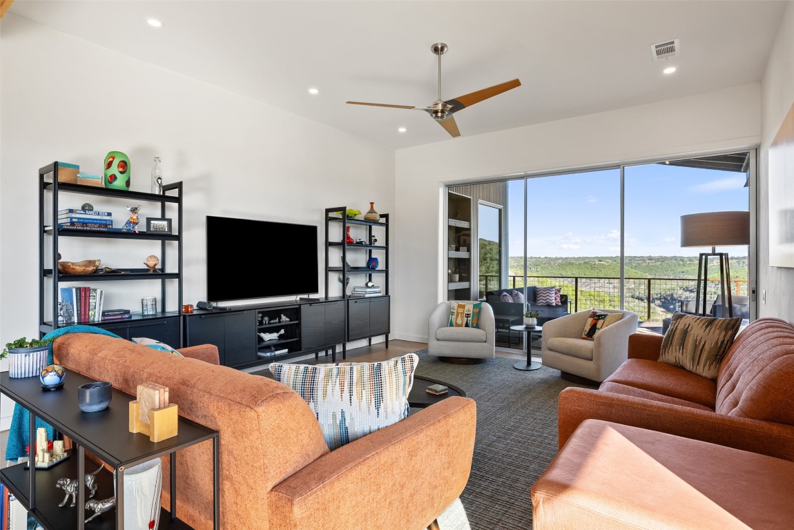 2037 Wolf Creek Ranch Road Burnet, TX 78611 - Photo 19 of 40 a living room with furniture a flat screen tv and a large window
