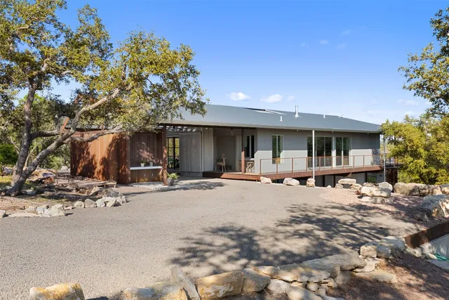 a wooden bench sitting in front of a building