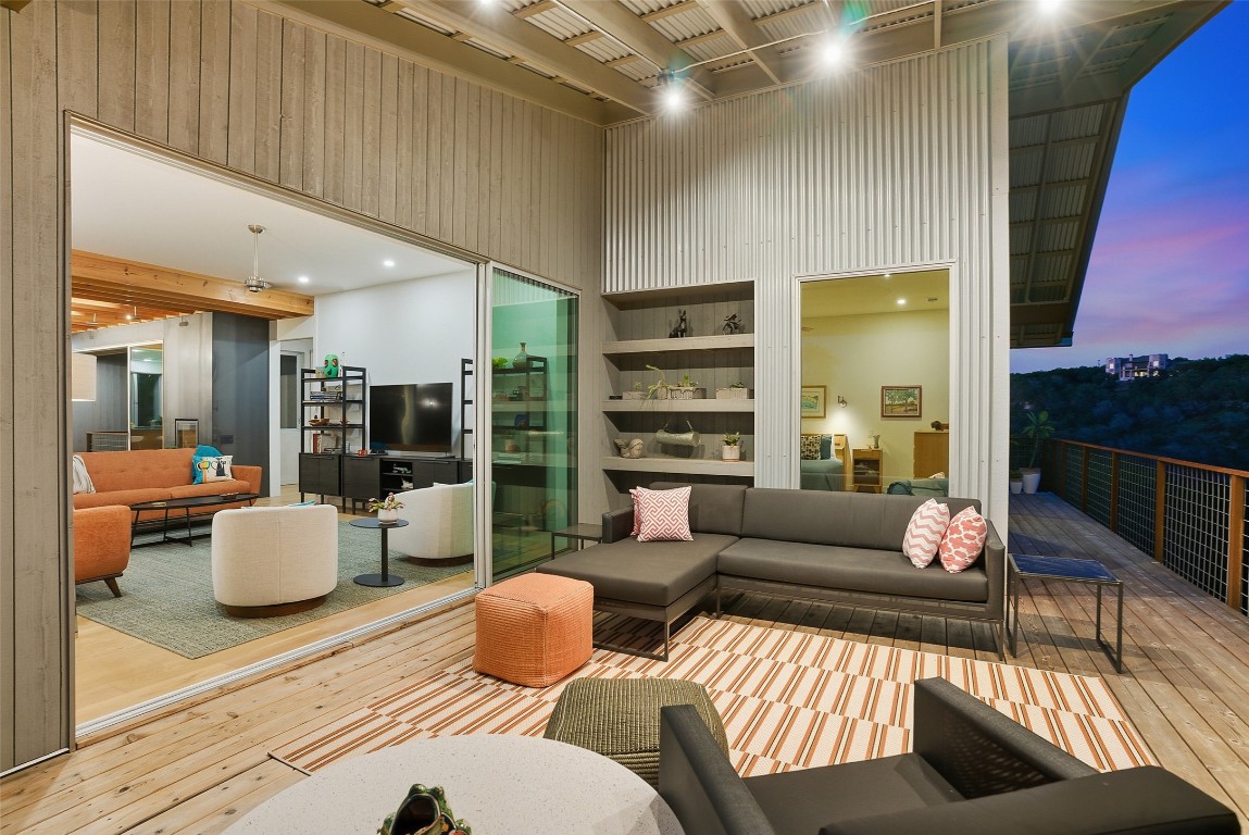 2037 Wolf Creek Ranch Road Burnet, TX 78611 - Photo 21 of 40 a living room with furniture wooden floor and a large window