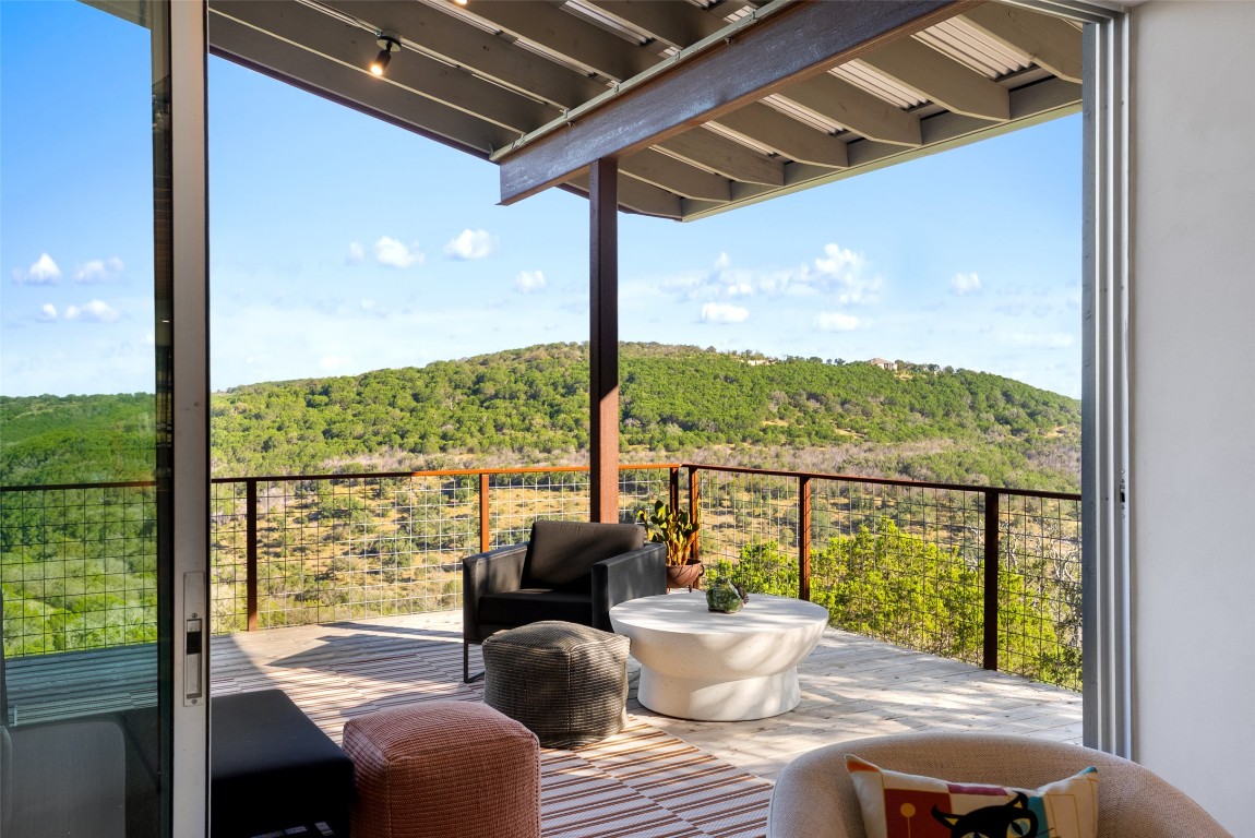2037 Wolf Creek Ranch Road Burnet, TX 78611 - Photo 22 of 40 a view of a porch with furniture and wooden floor