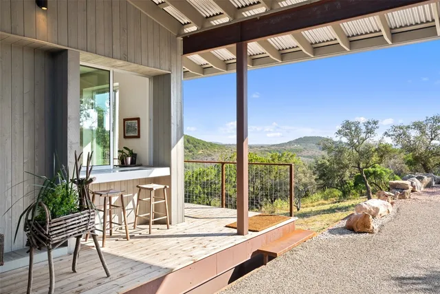 a building outdoor space with patio furniture and potted plants
