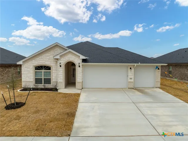 a front view of a house with yard