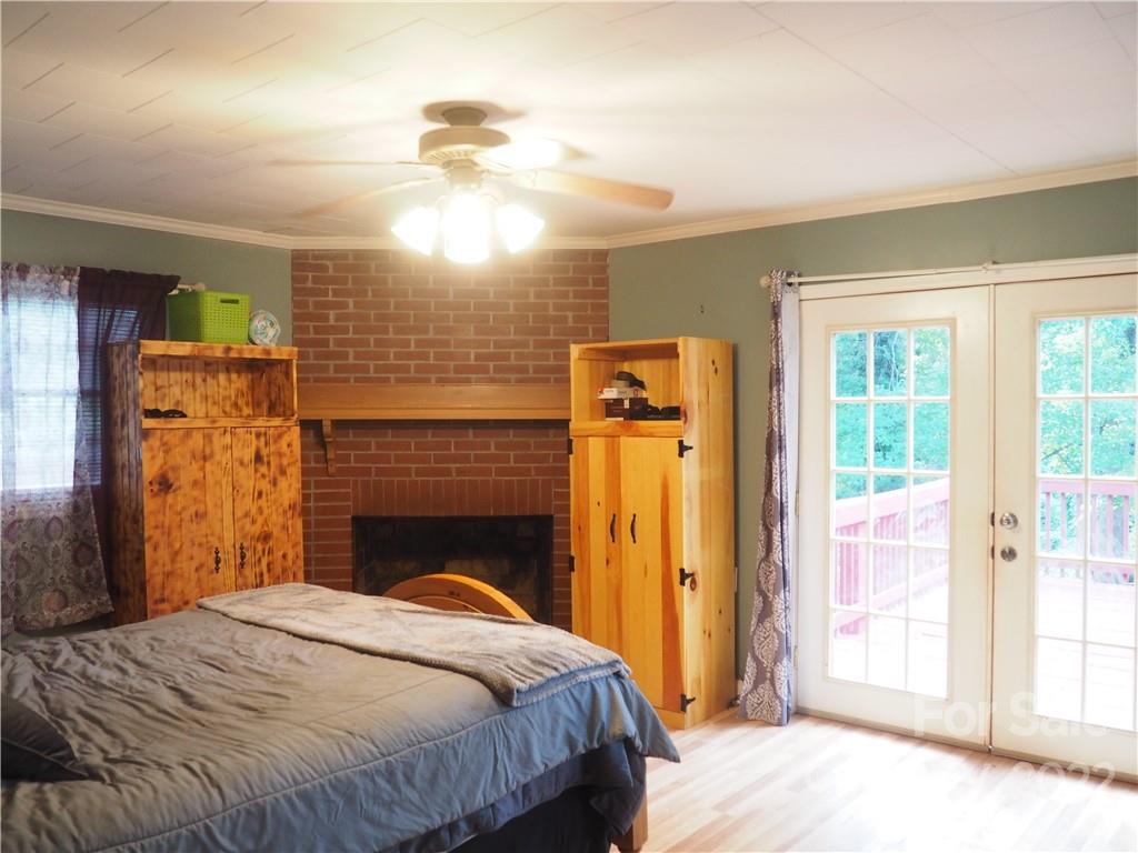 439 North Main Street Rutherfordton, NC 28139 - Photo 19 of 33 a bedroom with a bed and a fireplace