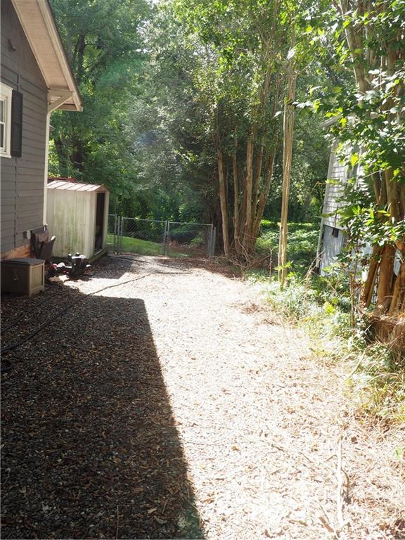 439 North Main Street Rutherfordton, NC 28139 - Photo 28 of 33 a backyard of a house with large trees and wooden fence