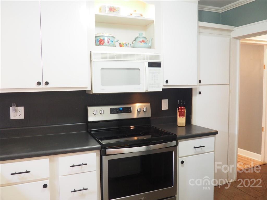 439 North Main Street Rutherfordton, NC 28139 - Photo 10 of 33 a kitchen with stainless steel appliances granite countertop a stove and a microwave
