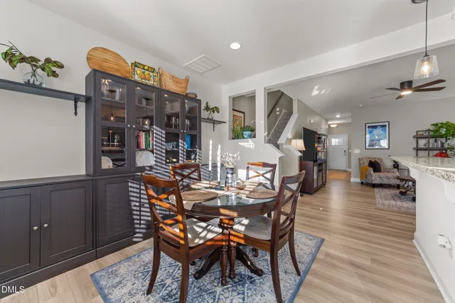 a dining room with furniture and wooden floor