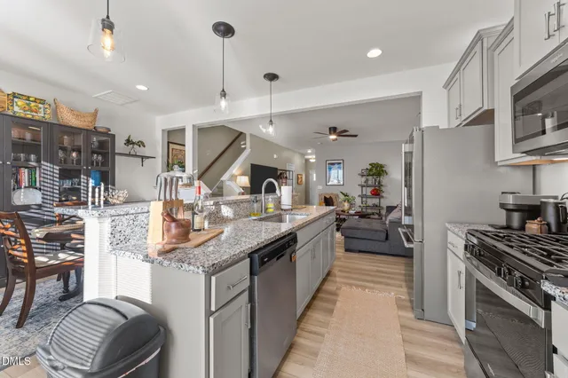 a kitchen with stainless steel appliances granite countertop a sink counter space cabinets and a stove