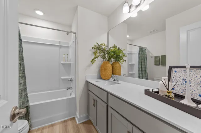 a bathroom with a tub sink and mirror