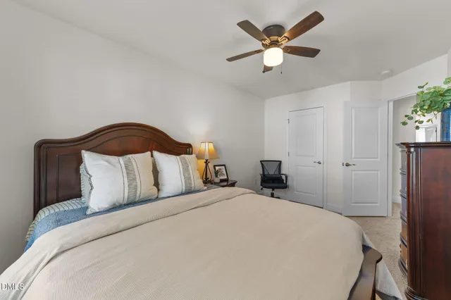a bedroom with a bed and a ceiling fan
