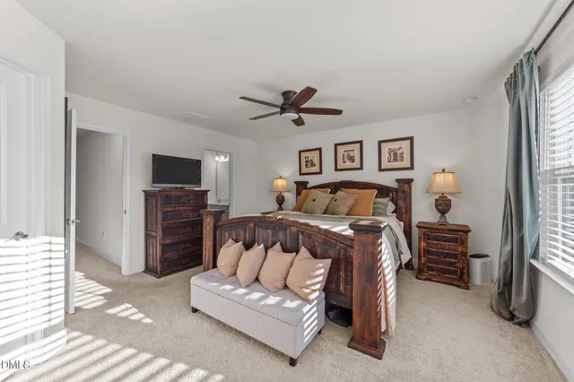 a bedroom with a bed and a television