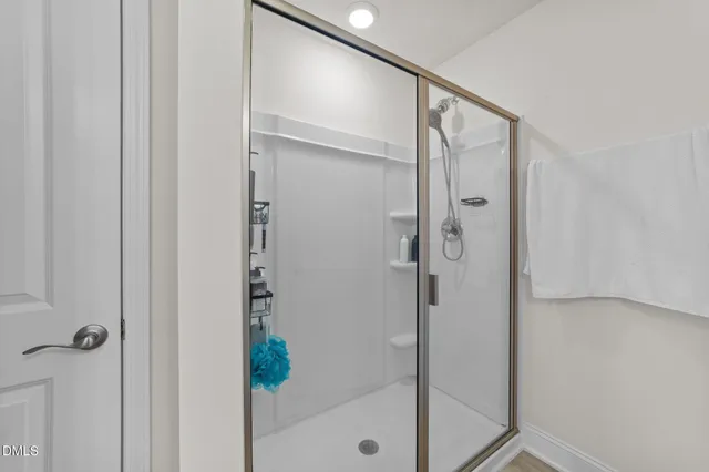 a bathroom with a glass shower door