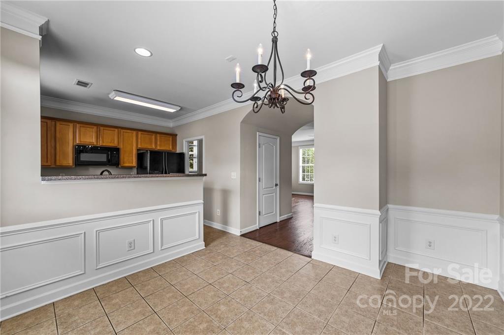 10559 Rocky Ford Club Road Charlotte, NC 28078 - Photo 6 of 18 a view of a kitchen with a sink and a chandelier