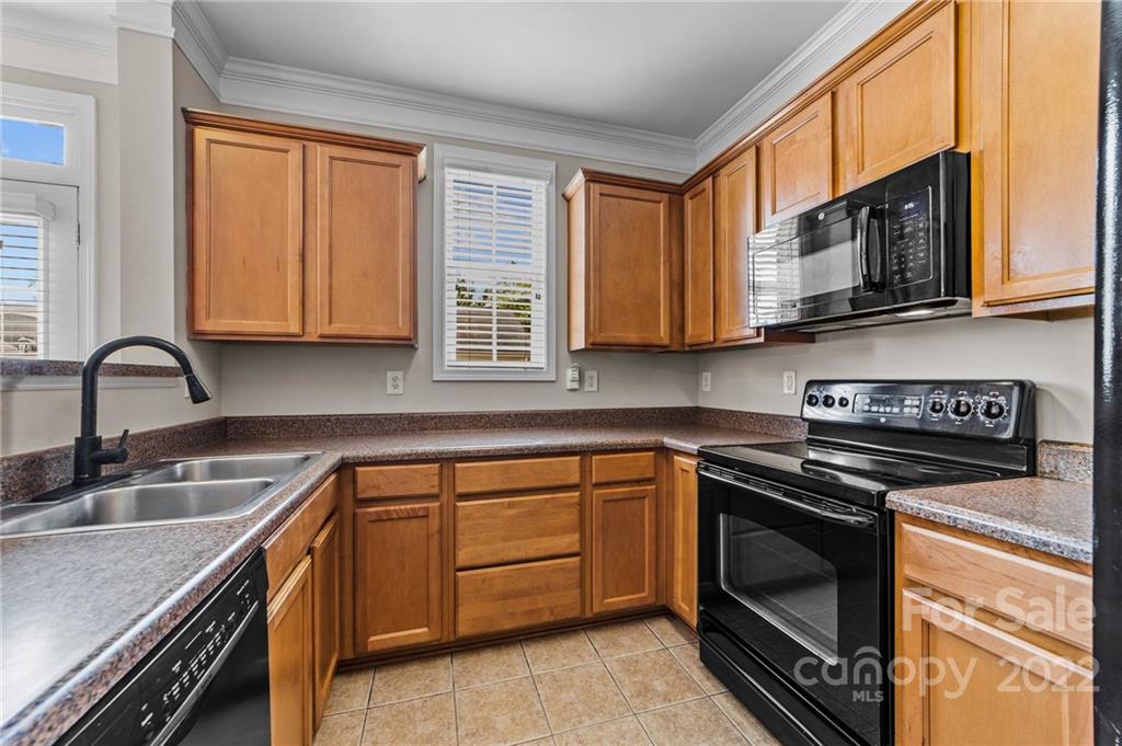 10559 Rocky Ford Club Road Charlotte, NC 28078 - Photo 7 of 18 a kitchen with stainless steel appliances granite countertop a sink stove and microwave