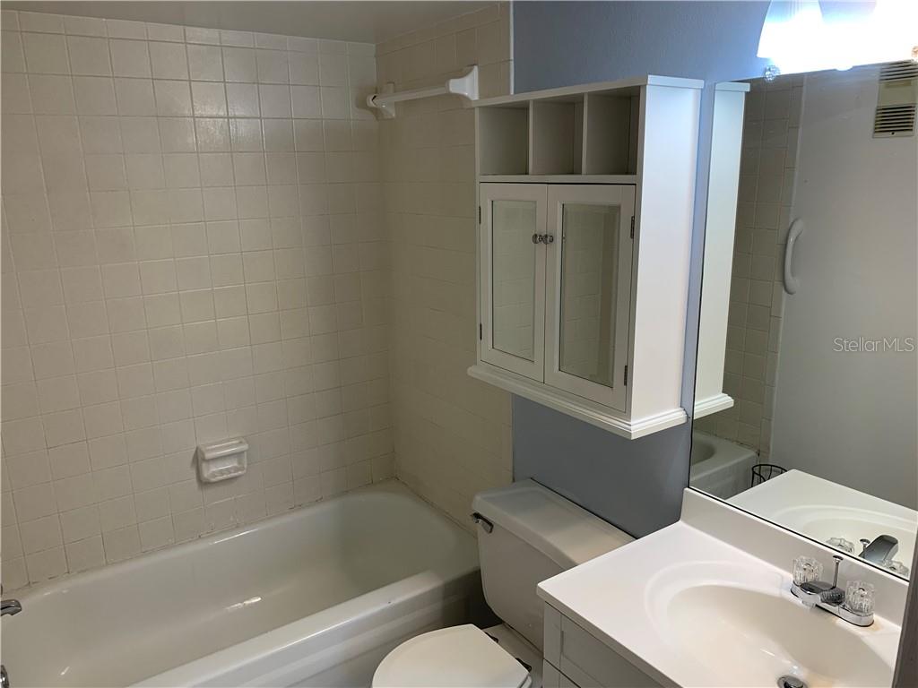 5993 Village Circle North, Unit GE Orlando, FL 32822 - Photo 7 of 16 a bathroom with a sink toilet and shower