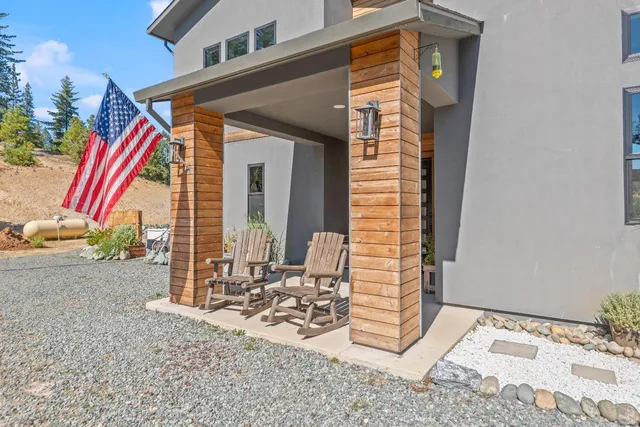 a large white kitchen with stainless steel appliances kitchen island granite countertop a lot of counter space and wooden floor