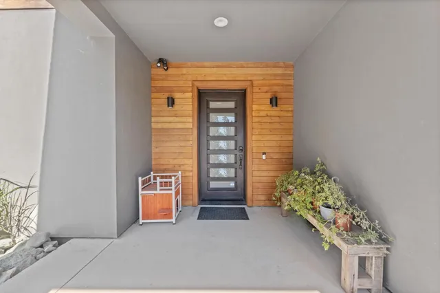a large kitchen with stainless steel appliances granite countertop a lot of counter space and wooden floor