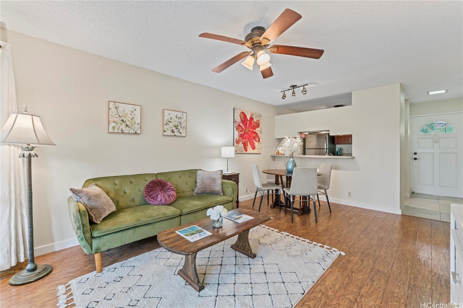 a living room with furniture kitchen view and a dining table