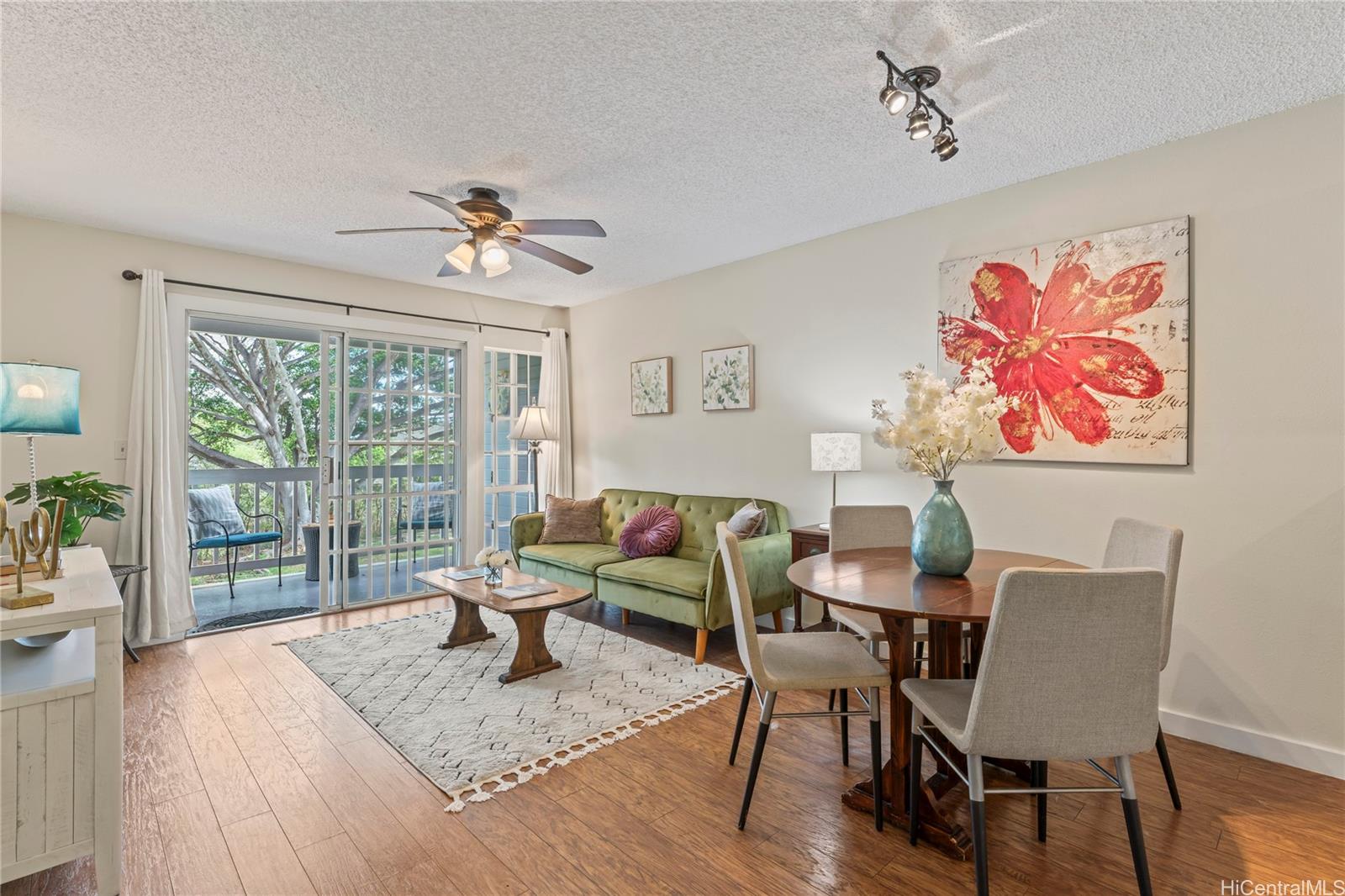 92-1136 Hame Street, Unit 10102 Kapolei, HI 96707 - Photo 3 of 22 a view of a dining room with furniture wooden floor and a chandelier