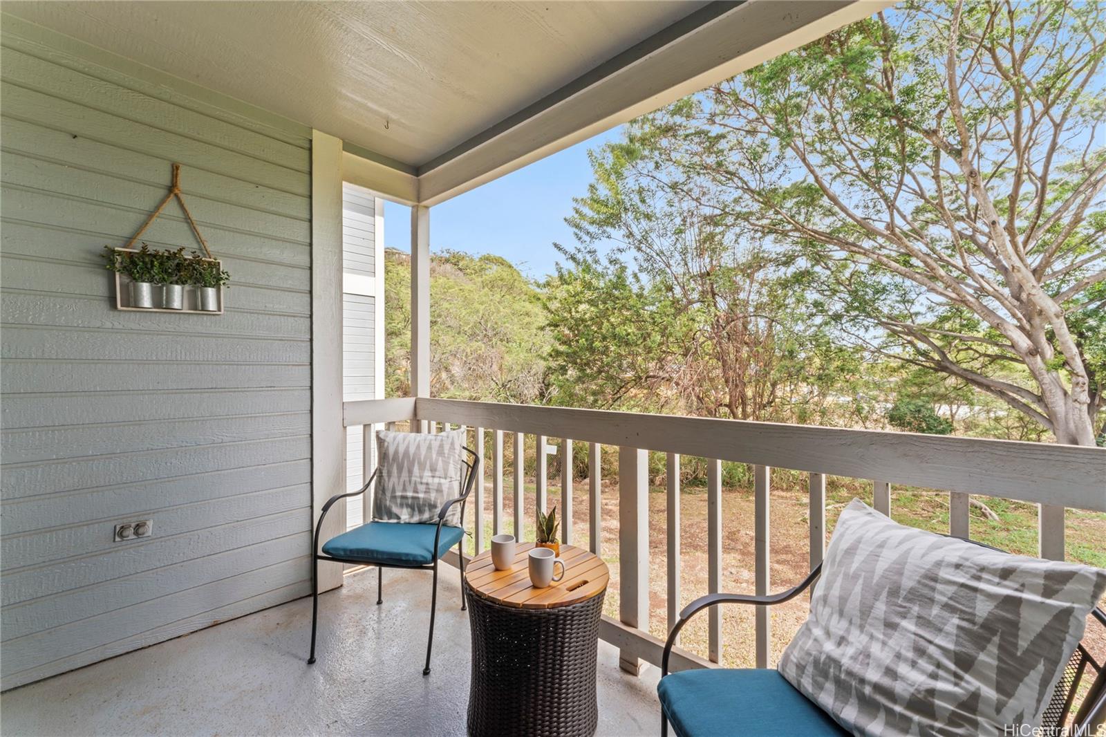 92-1136 Hame Street, Unit 10102 Kapolei, HI 96707 - Photo 9 of 22 a view of a chair and table in the balcony