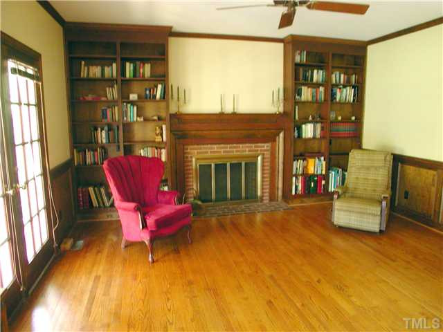 2323 Hales Road Raleigh, NC 27608 - Photo 3 of 15 ,,,this comfortable family room with gas-log equipped masonry fireplace and built-in bookcases.