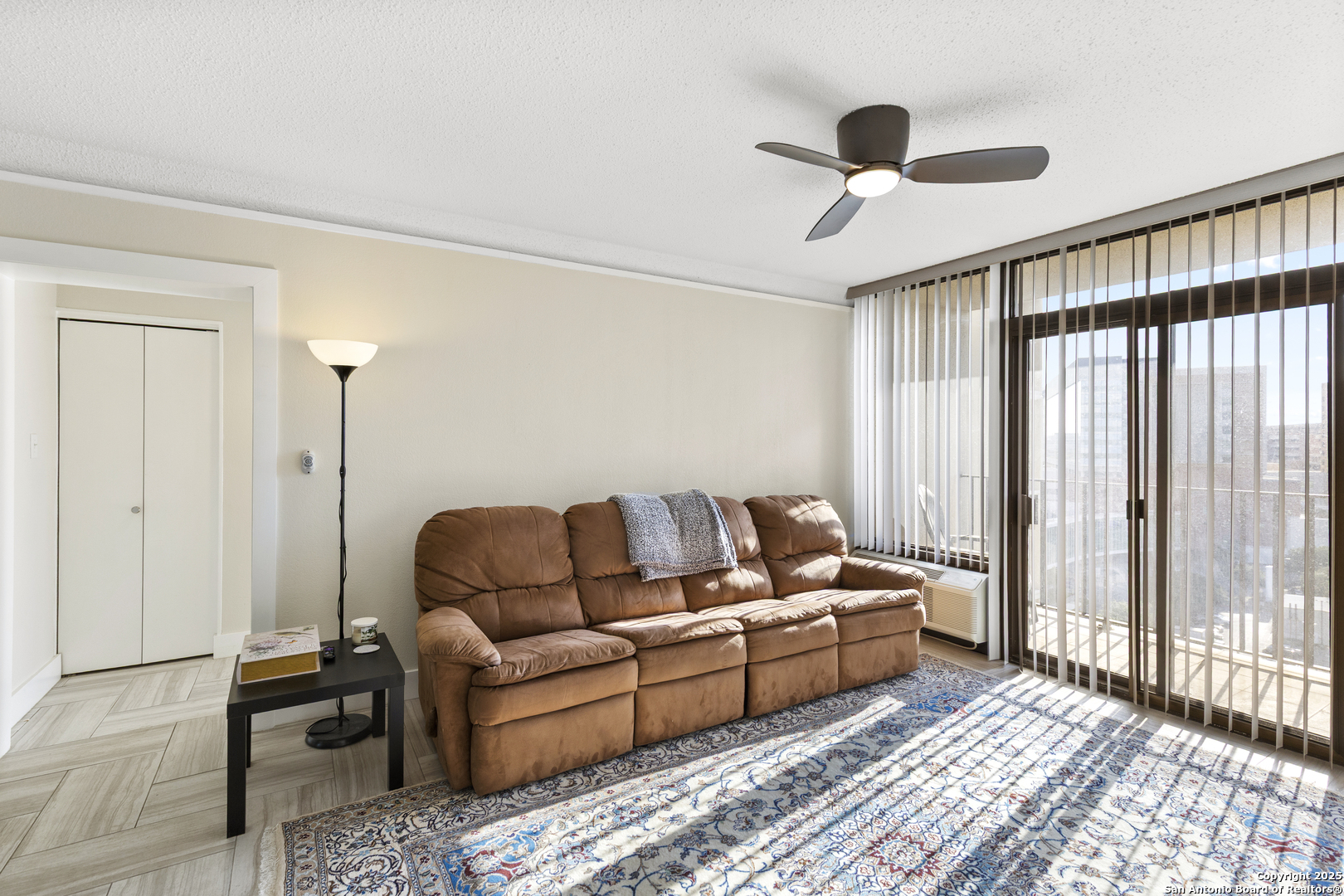 7701 Wurzbach Road, Unit 1701 San Antonio, TX 78229 - Photo 11 of 41 a living room with furniture and a large window