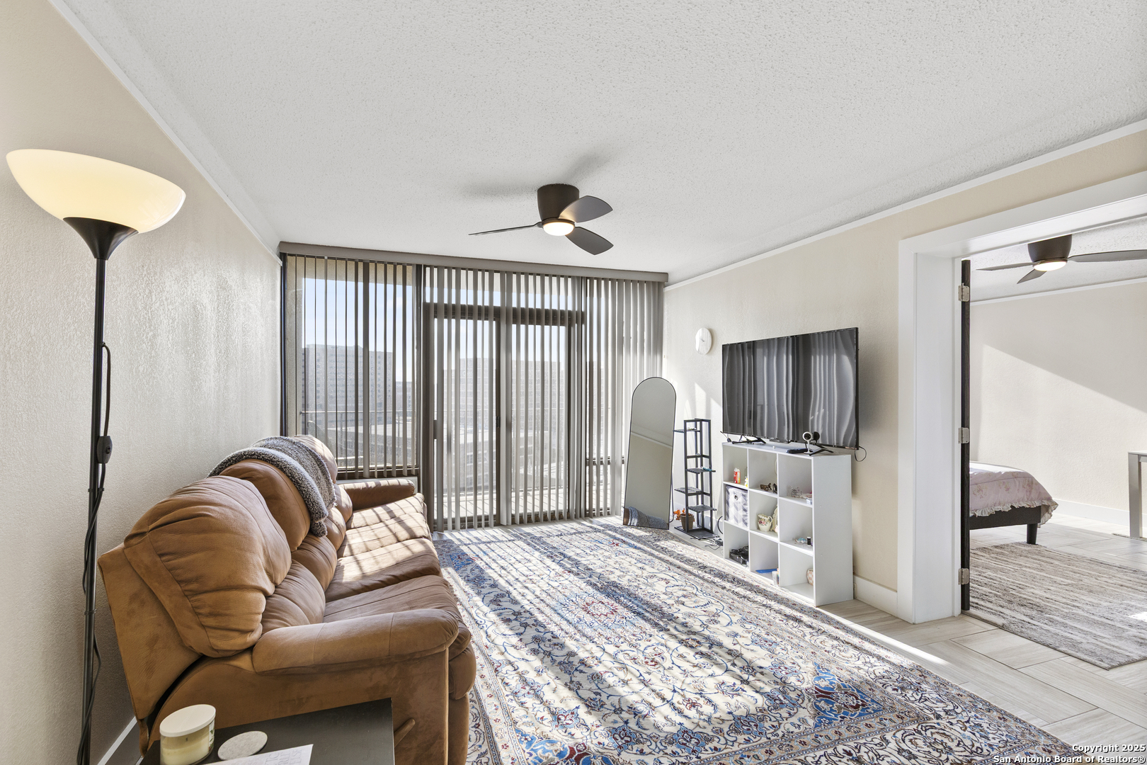 7701 Wurzbach Road, Unit 1701 San Antonio, TX 78229 - Photo 12 of 41 a bedroom with furniture and a flat screen tv