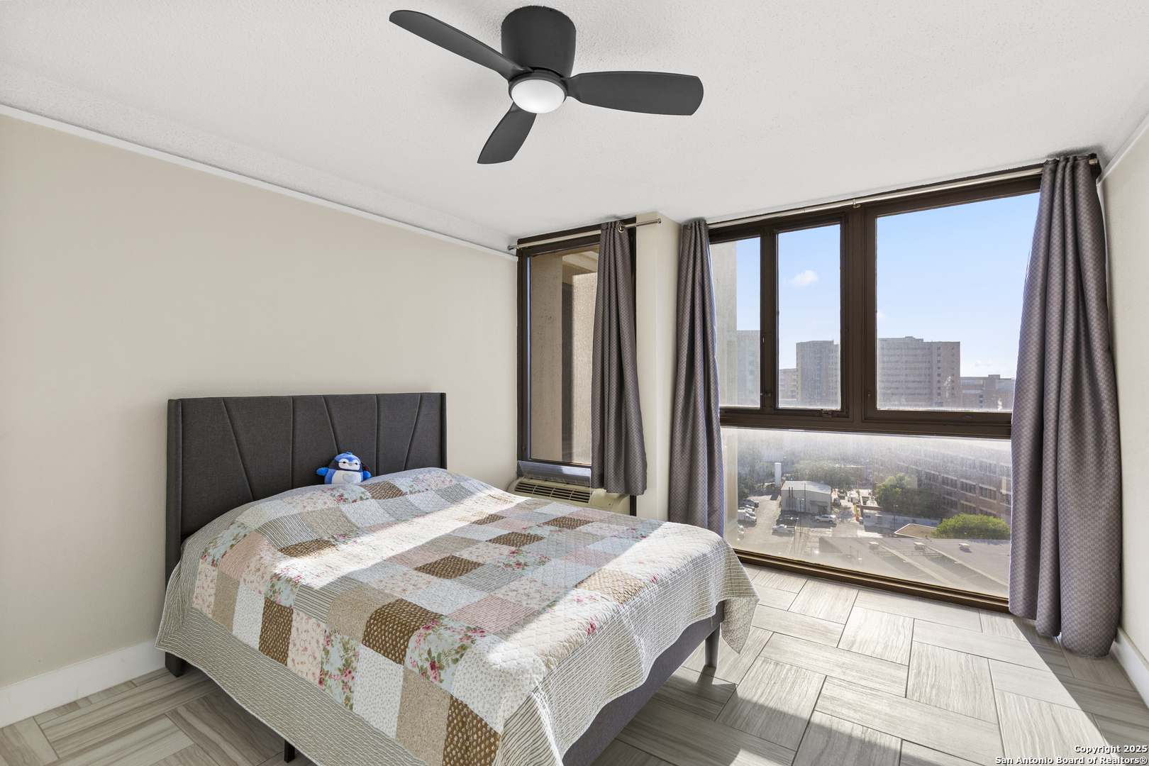 7701 Wurzbach Road, Unit 1701 San Antonio, TX 78229 - Photo 18 of 41 a bedroom with a large bed and a large window