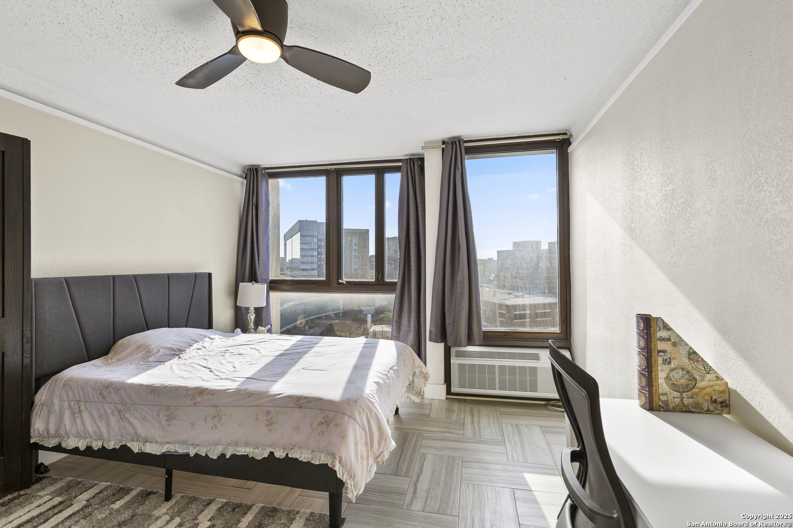 7701 Wurzbach Road, Unit 1701 San Antonio, TX 78229 - Photo 21 of 41 a bedroom with a bed and a large window