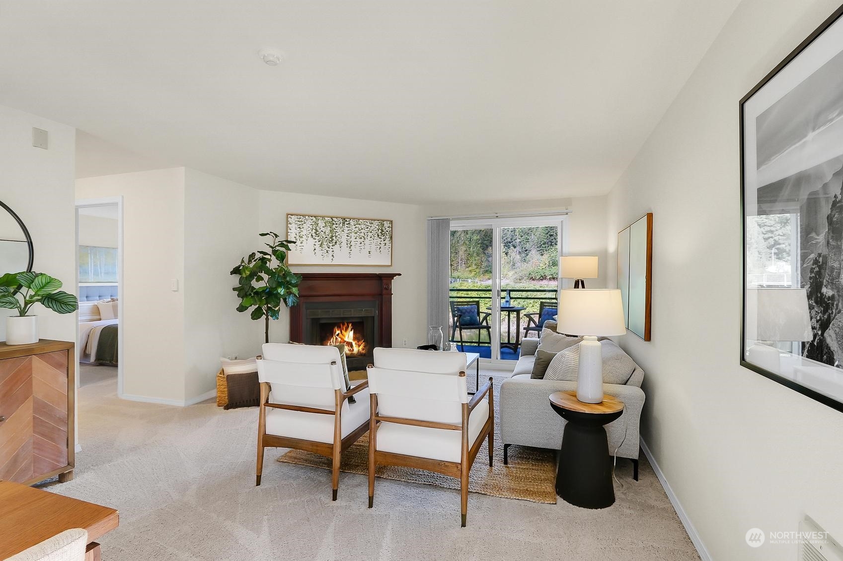10822 East Riverside Drive, Unit A203 Bothell, WA 98011 - Photo 2 of 20 a living room with furniture a fireplace and a potted plant