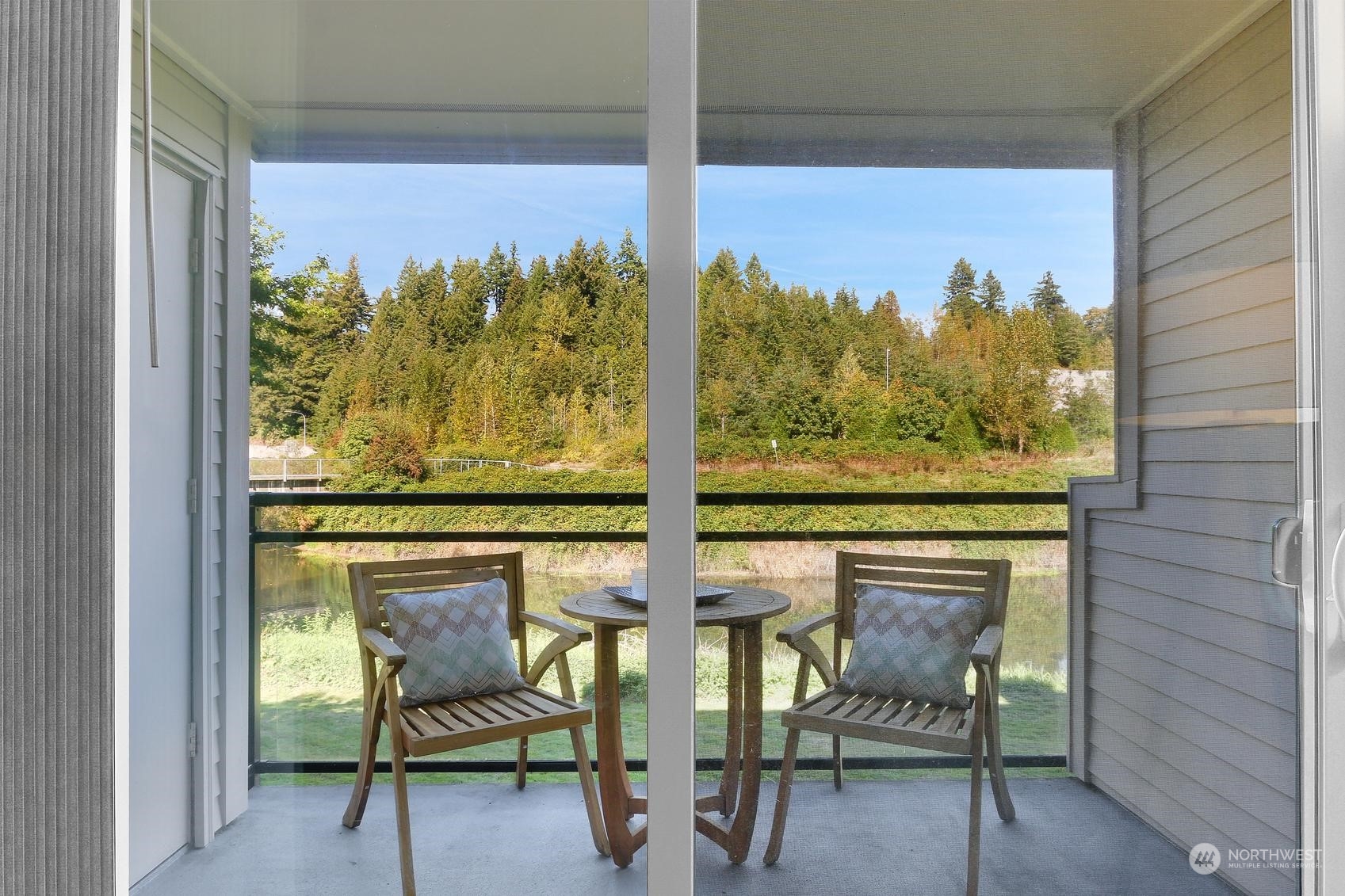 10822 East Riverside Drive, Unit A203 Bothell, WA 98011 - Photo 4 of 20 a view of two chairs in a room next to a window
