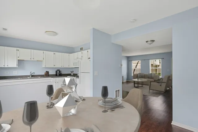 a kitchen with a table chairs stove and cabinets