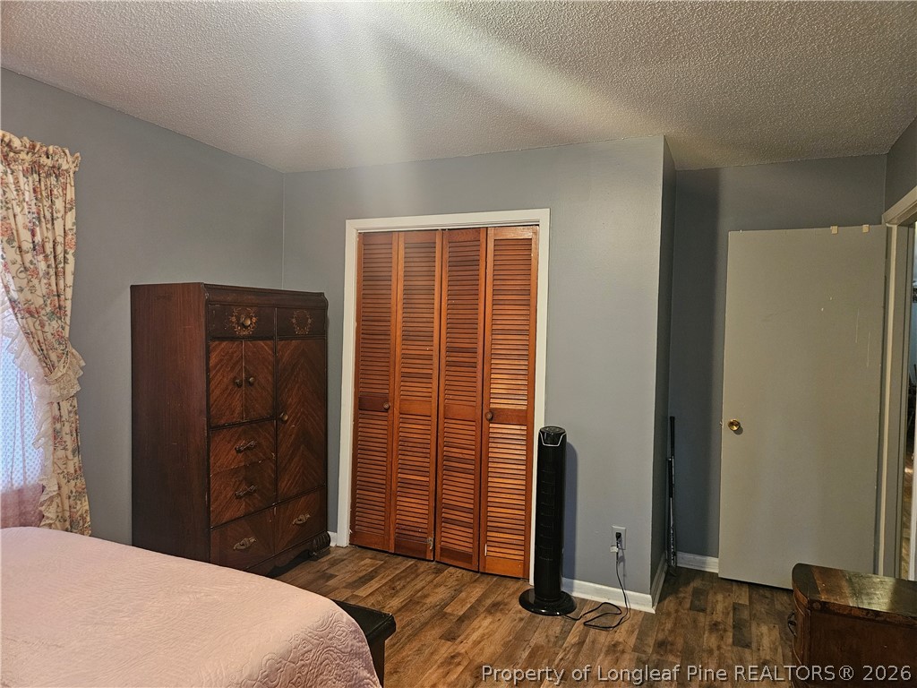 4547 Legion Road Hope Mills, NC 28348 - Photo 25 of 28 a bedroom with a bed and a dresser