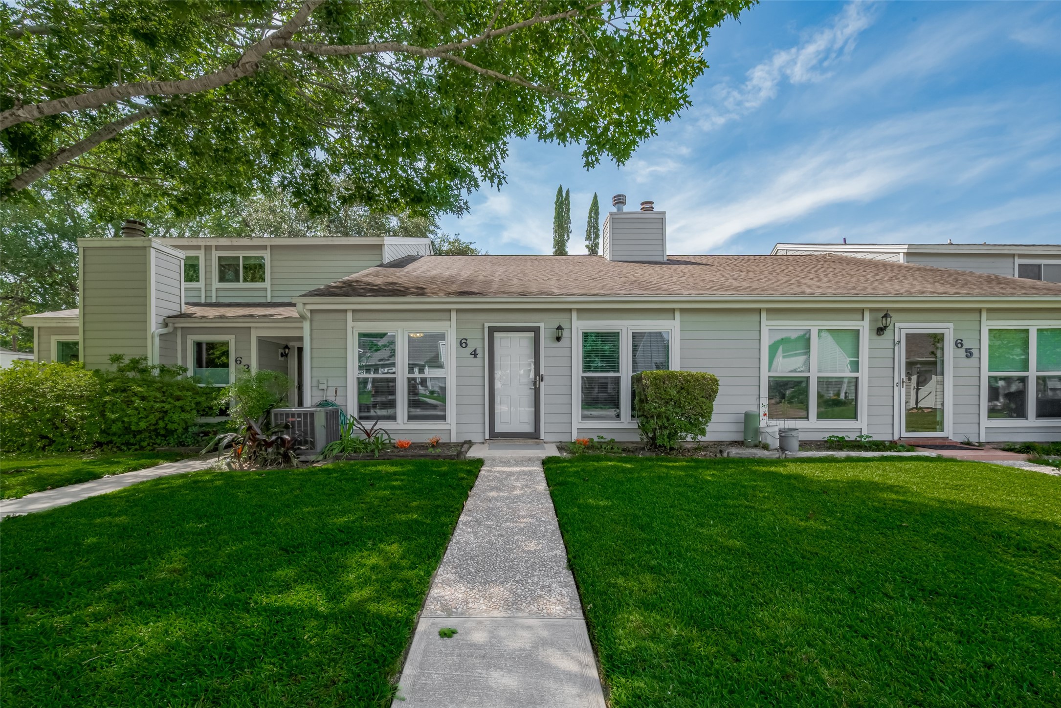 64 Hideaway Drive Friendswood, TX 77546 - Photo 1 of 33 front view of a brick house with a yard