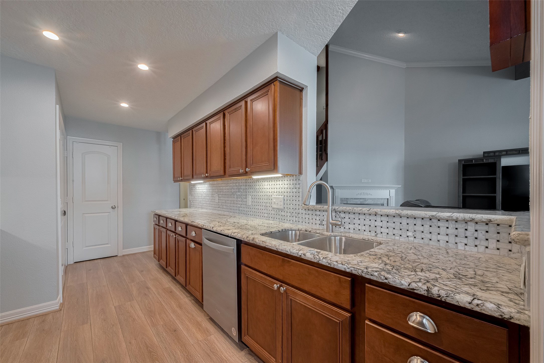 64 Hideaway Drive Friendswood, TX 77546 - Photo 12 of 33 a kitchen with stainless steel appliances granite countertop a sink stove and cabinets