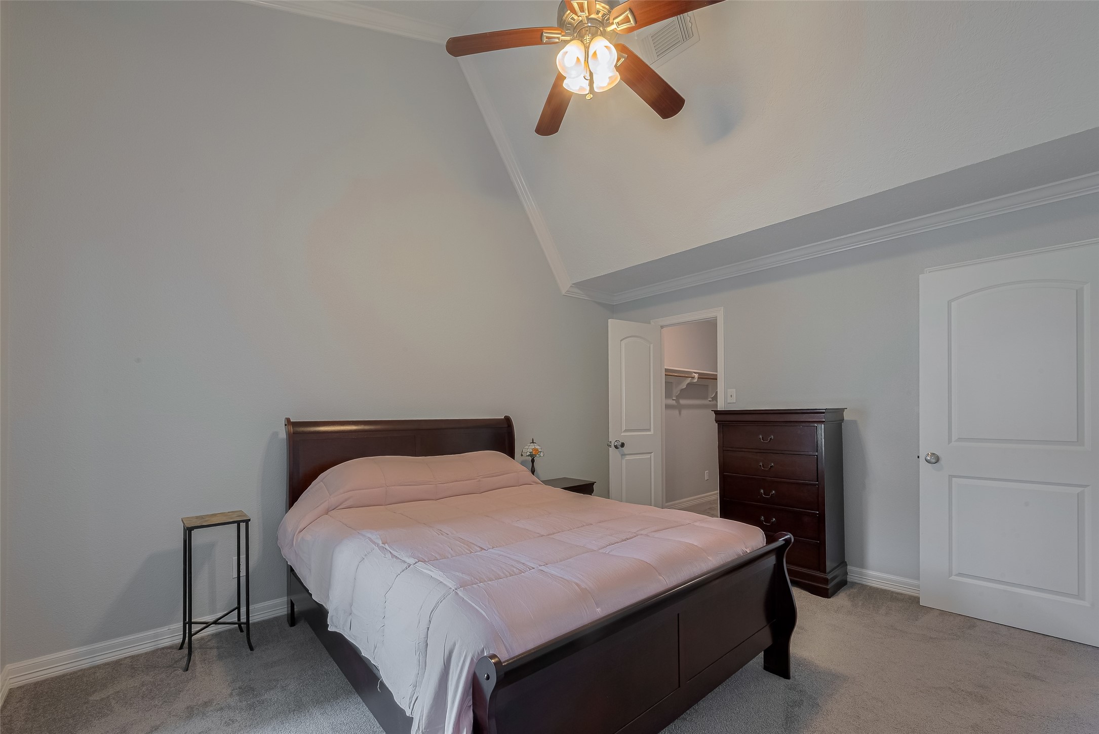 64 Hideaway Drive Friendswood, TX 77546 - Photo 16 of 33 a bedroom with a bed and a chandelier