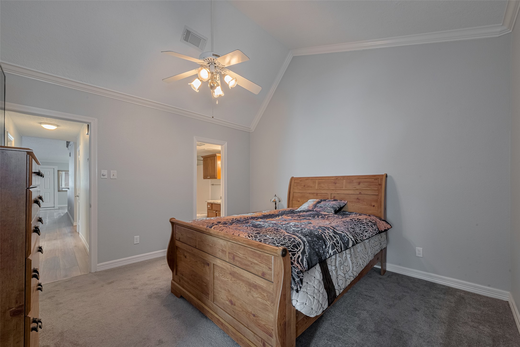 64 Hideaway Drive Friendswood, TX 77546 - Photo 22 of 33 a bedroom with a bed and a chandelier