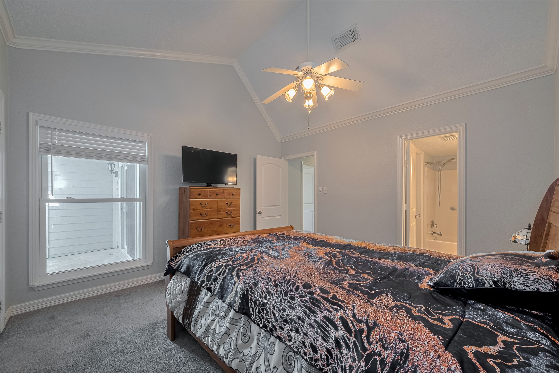 64 Hideaway Drive Friendswood, TX 77546 - Photo 23 of 33 a bedroom with a large bed and a tv