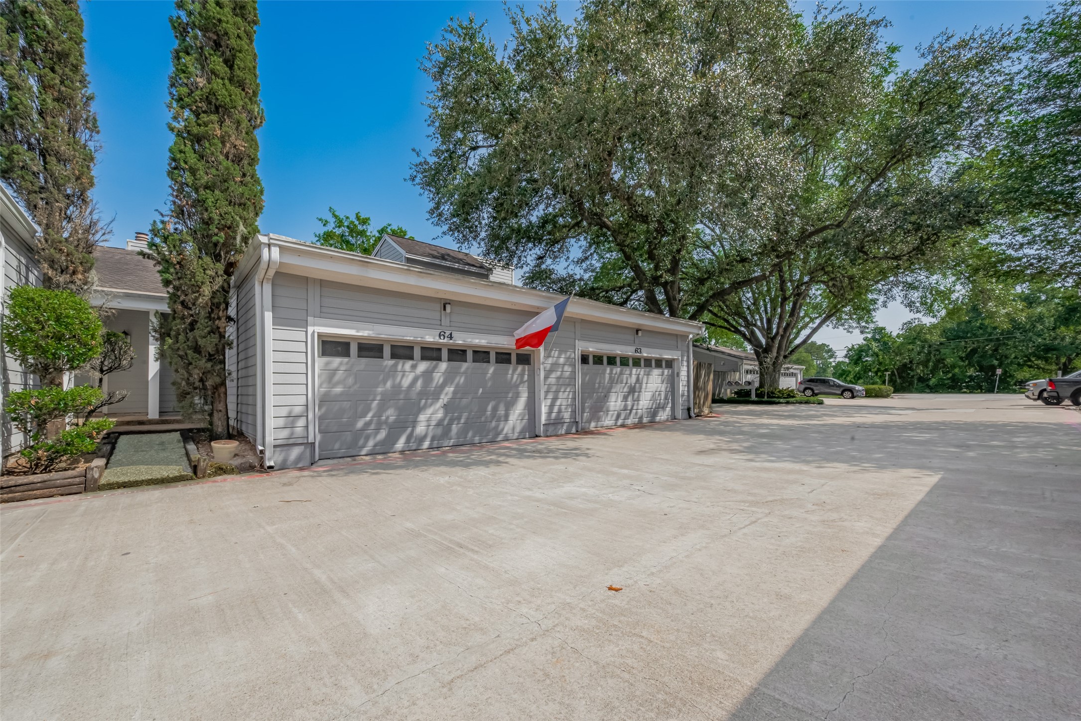 64 Hideaway Drive Friendswood, TX 77546 - Photo 28 of 33 a front view of a house with a yard and garage